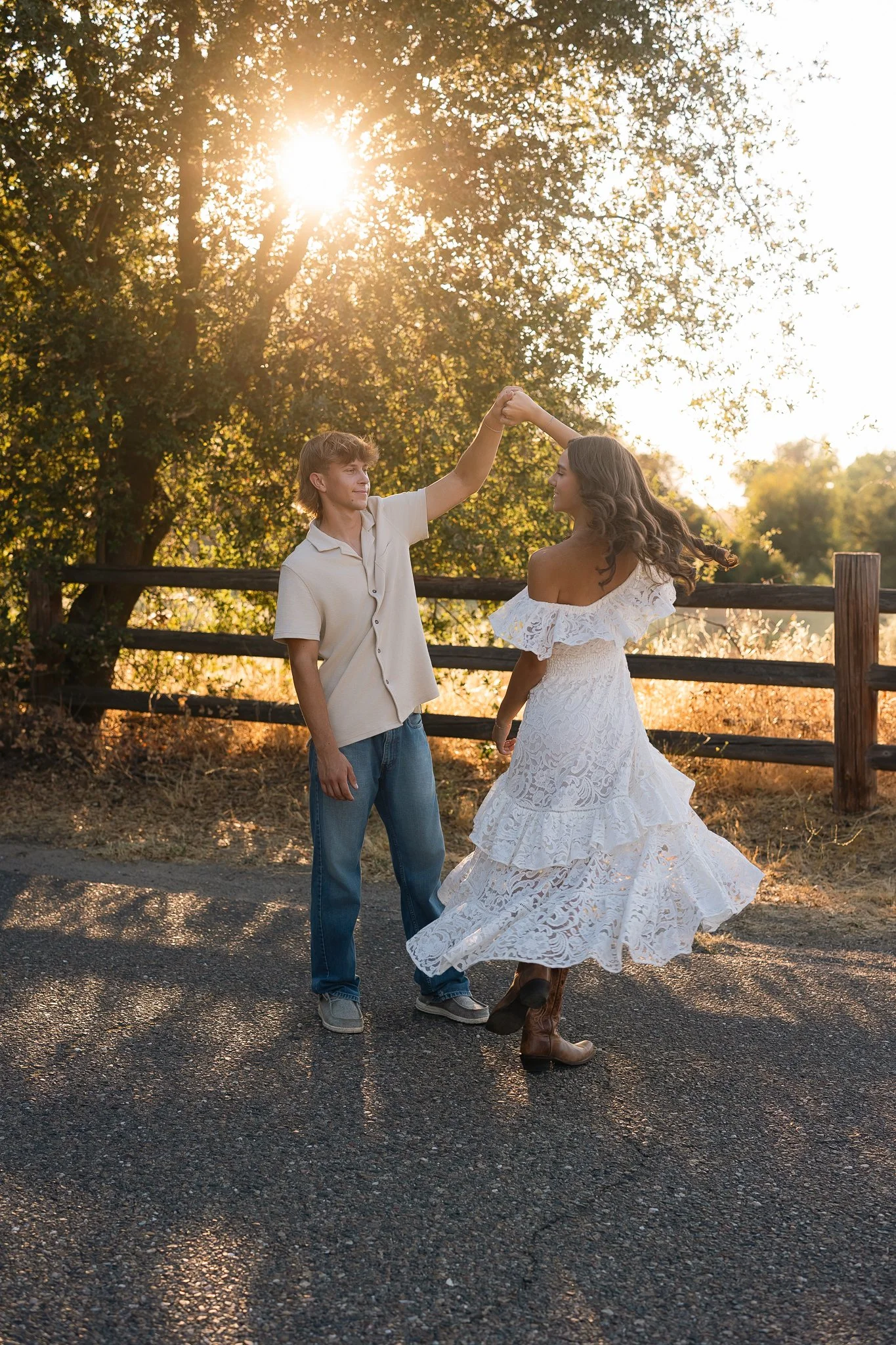 Pleasant Grove High School Class of 2027 graduating senior twirling in a white dress during golden hour senior pictures at Cosumnes River Preserve near Elk Grove, California.