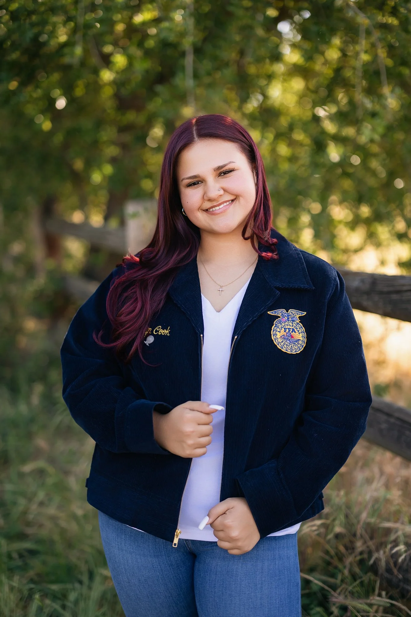 Pleasant Grove High School graduating senior wearing her FFA jacket during her senior picture session in Elk Grove, California.