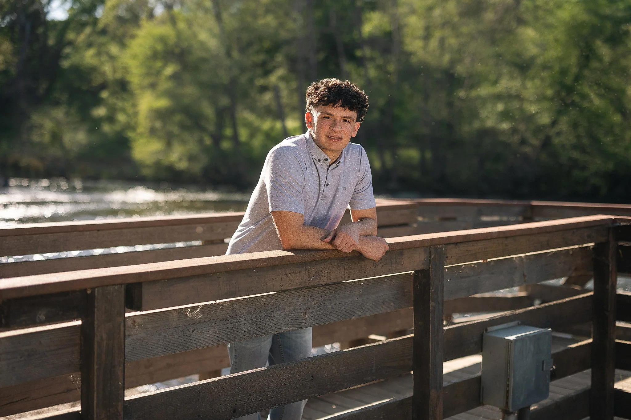 Outdoor senior picture idea for guys featuring a Lodi High School senior in a casual button-down shirt during his senior portrait session along the Mokelumne River in Lodi, California.