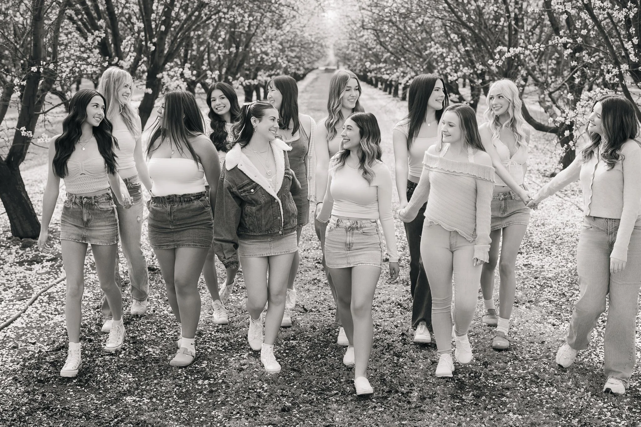 Senior Model Team posing in the almond blossoms for a team photoshoot
