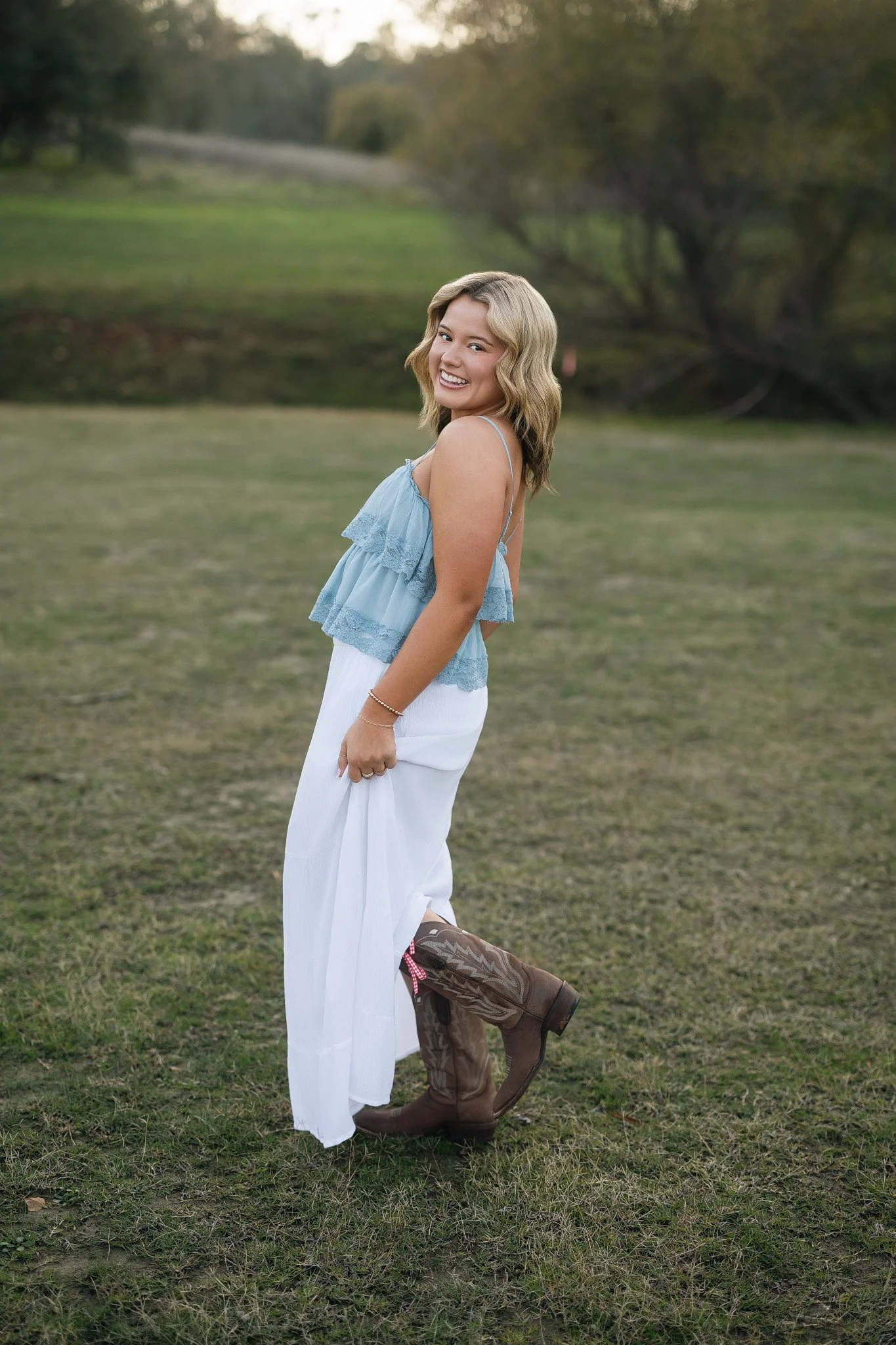 Oak Ridge High School senior posing in cowboy boots during her senior pictures at Folsom Lake in Folsom, California.