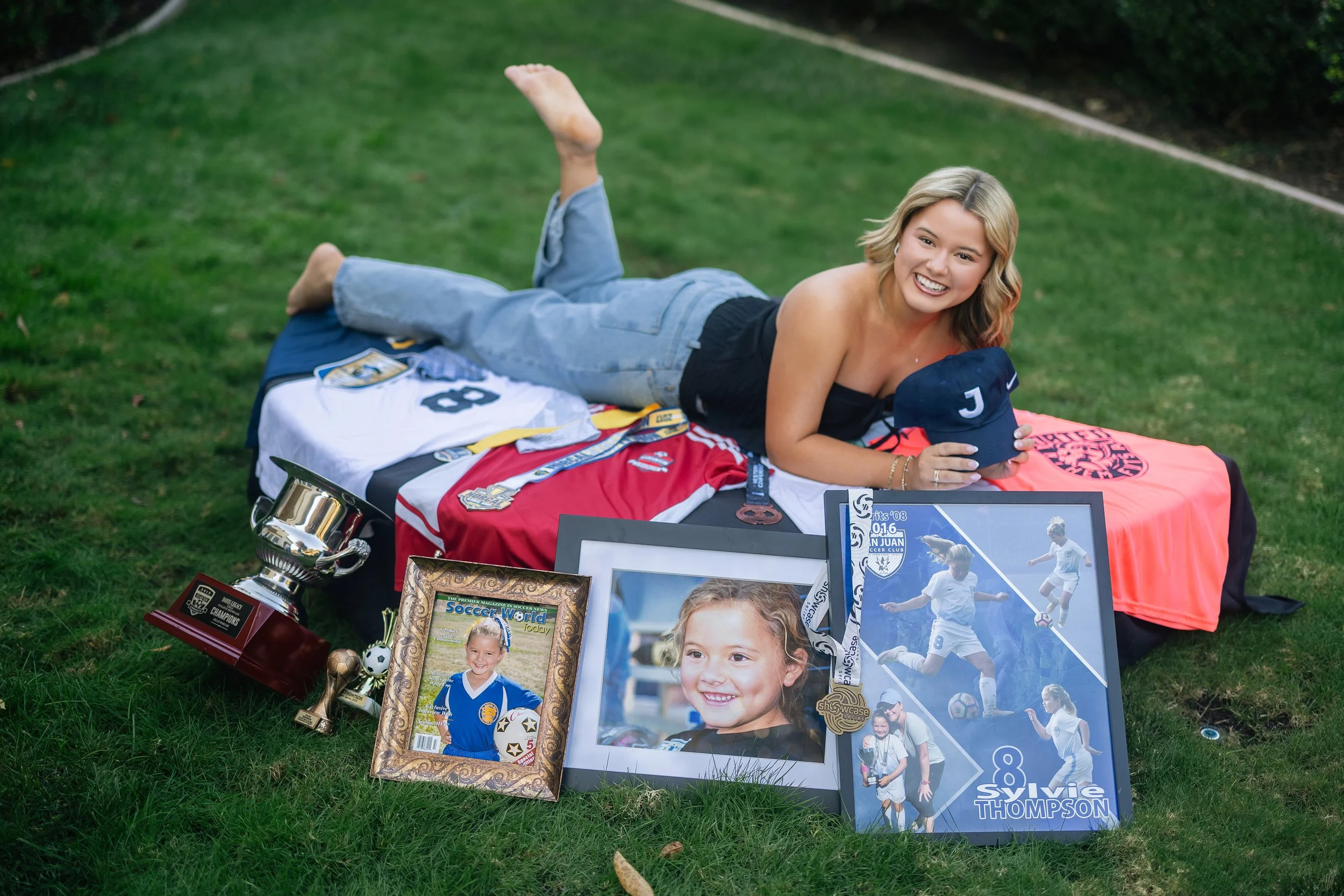 Oak Ridge High School senior celebrating her soccer journey with jerseys, trophies, medals and childhood photos during her senior picture session in Folsom, California.