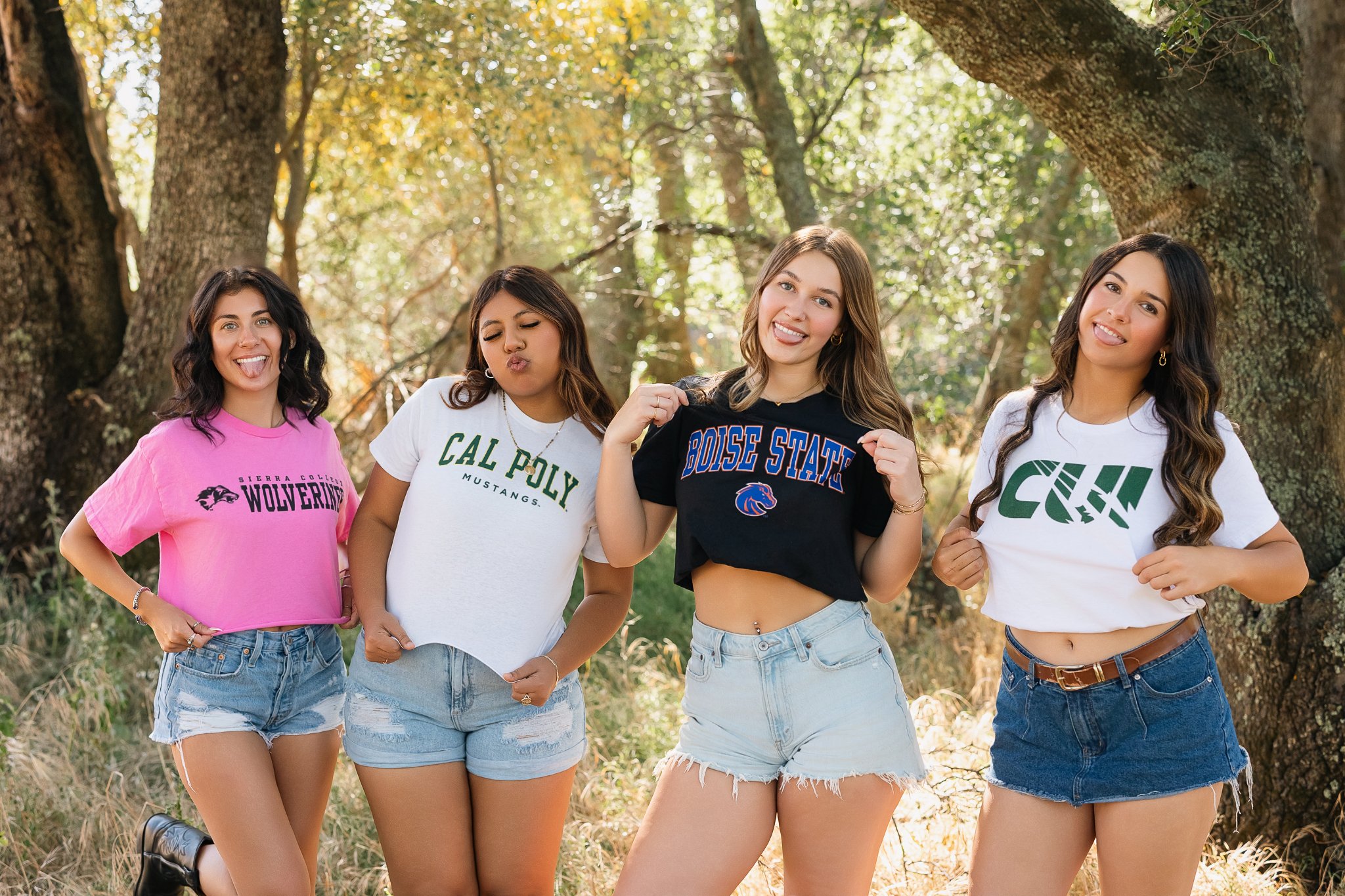 Four MC Senior VIP Team members showing off their college shirts during a college announcement photoshoot celebrating their plans after high school.