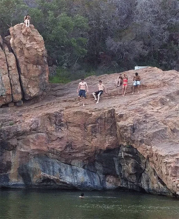 Photo taken seconds before I simultaneously busted my lip  and bikini top taking the highest cliff dive.