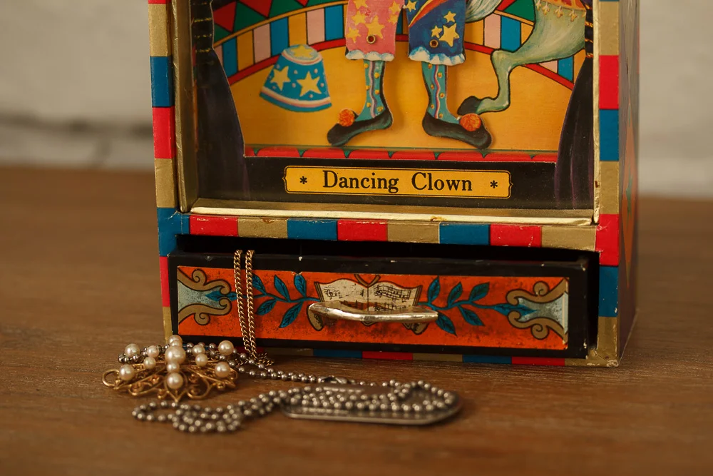 My childhood treasure. A music box my father gave me when I was five or six years old. Turn a little crank in back, open the drawer at the bottom, and the song "Send in the Clowns" plays. 