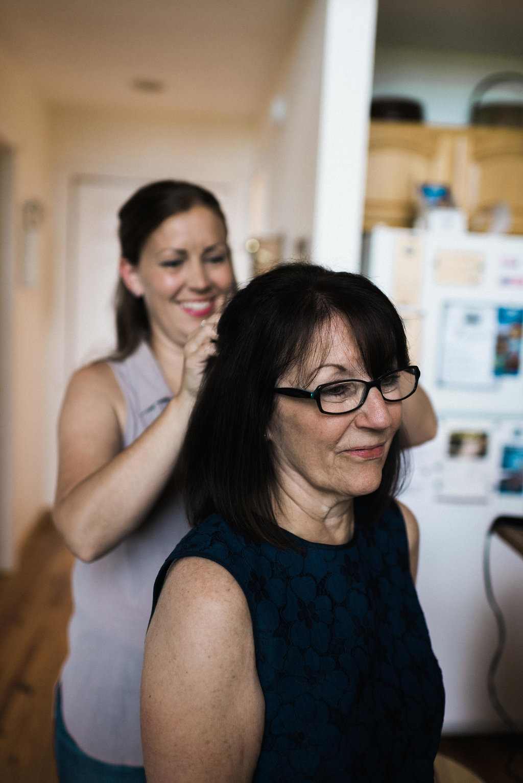 bride helping mom get ready