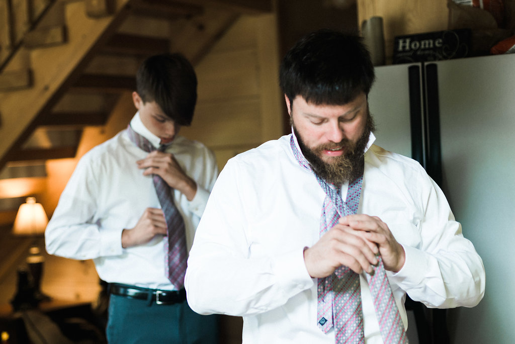 father and son getting ready for wedding