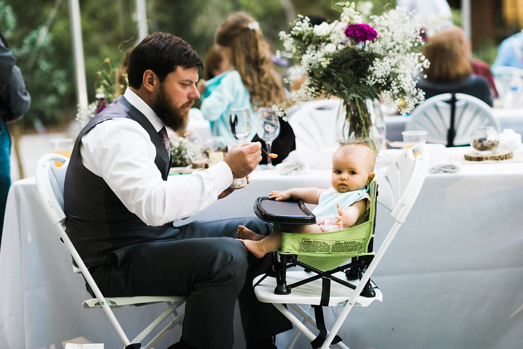 groom feeing daughter