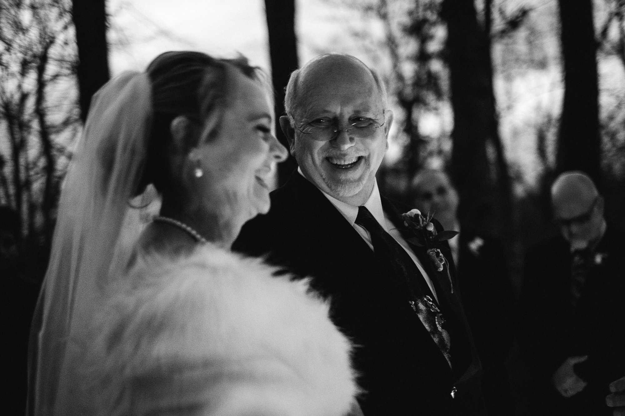 Candid shot of bride and groom laughing during ceremony