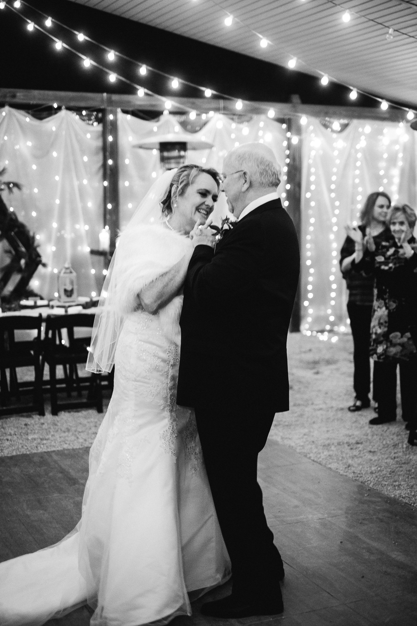Bride and groom laugh during first dance