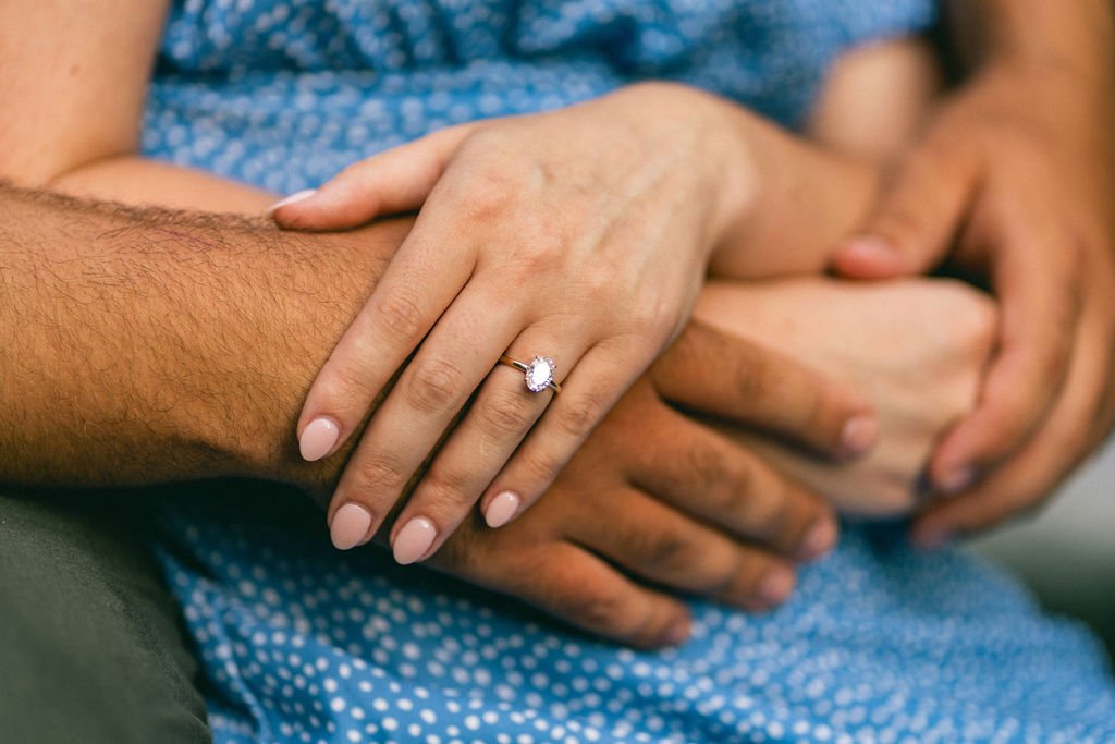 A close-up of an engagement ring, sparkling in the sunlight as a symbol of their commitment to each other.