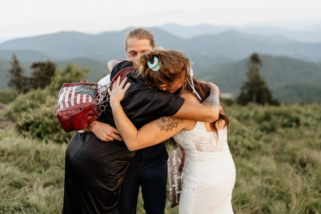 Intimate elopement moment—bride hugging parents during small Roan Mountain ceremony..jpg
