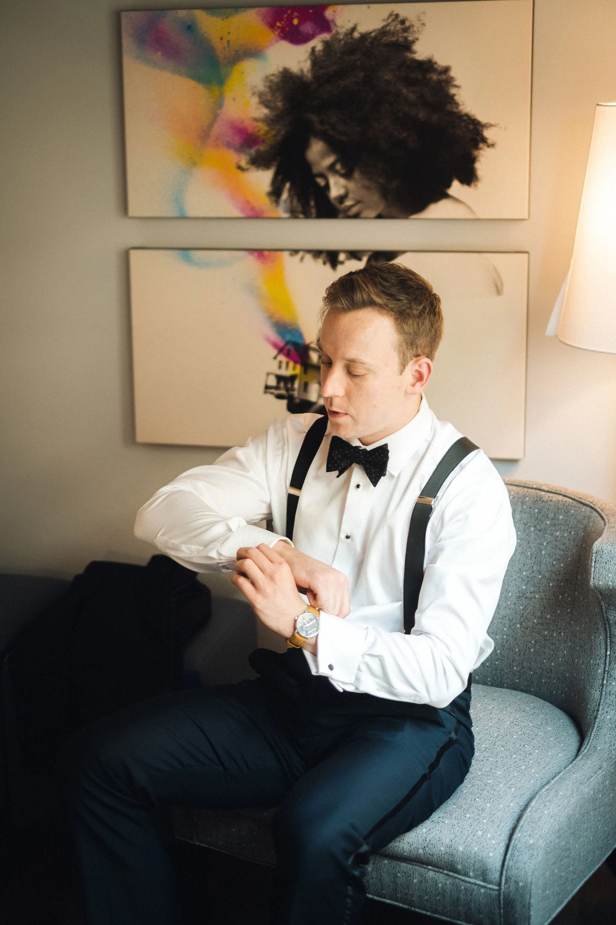 Groom fixing his suit.jpg