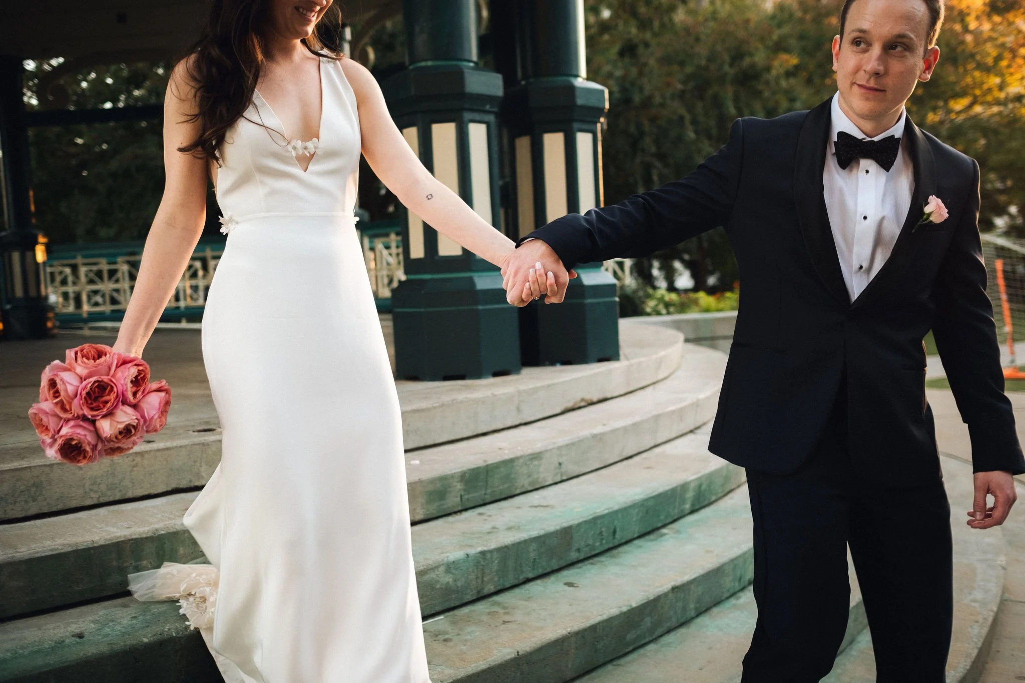 Bride and groom walking through the city streets, capturing the energy and movement of their wedding day..jpg