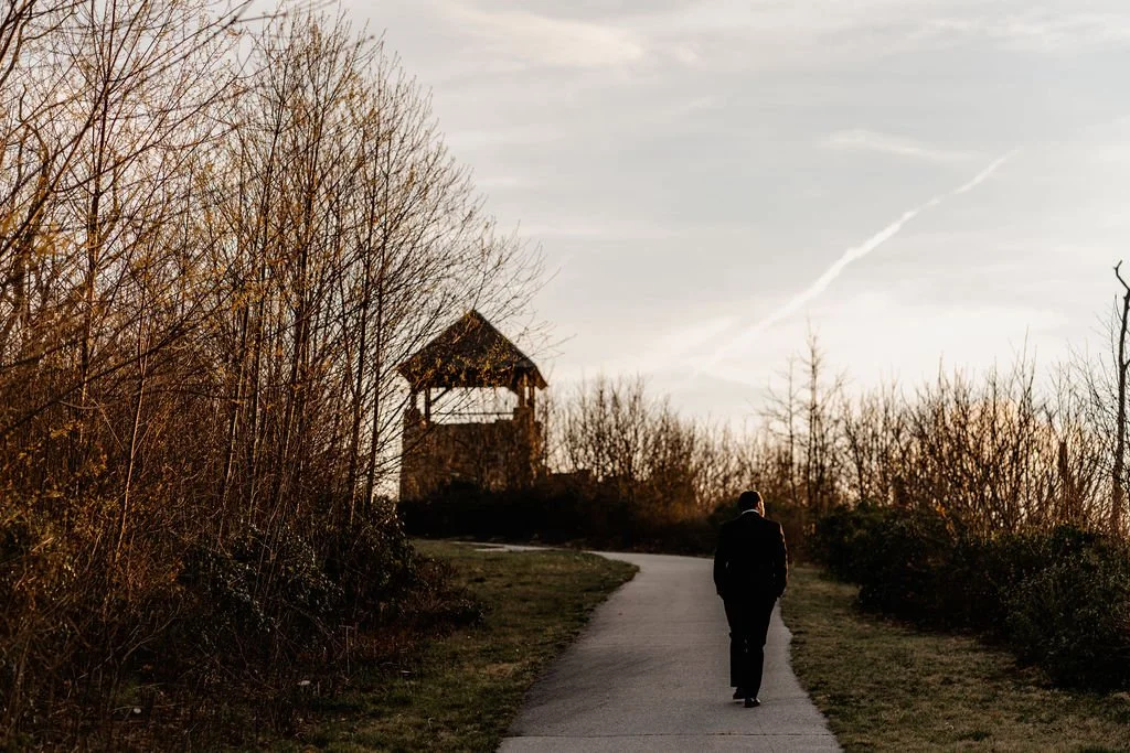 Bride walking the stone path toward Wayah Bald historic fire tower at golden hour during their intimate Appalachian elopement, Nantahala National Forest NC