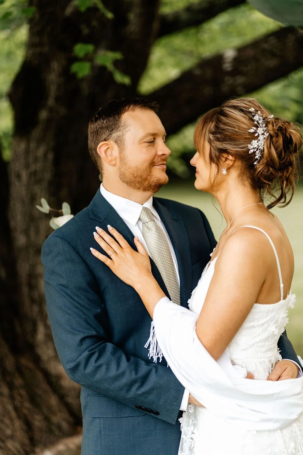 Close-up portrait of bride and groom gazing at each other under a large tree during an intimate Blue Ridge, Georgia wedding