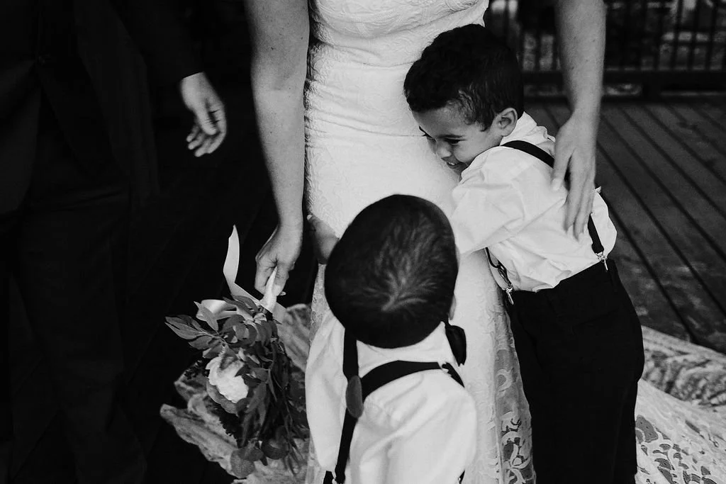 Children embracing their mother the bride in a candid family moment during an intimate Blue Ridge GA mountain wedding, Appalachian Wedding Photography