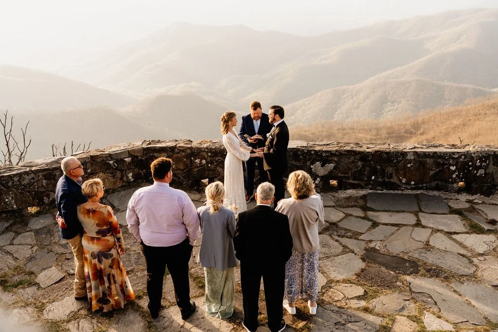 Victoria, Quinn, and their family gathered at Wayah Bald stone fire tower with four-state Appalachian mountain views during their intimate sunrise elopement, Nantahala NC