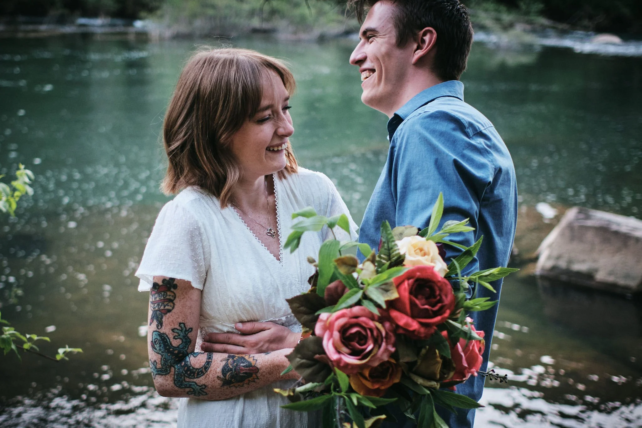Keene and Margo laughing together on a forested mountain path during their authentic Blue Ridge Georgia elopement, joyful candid Appalachian elopement photography