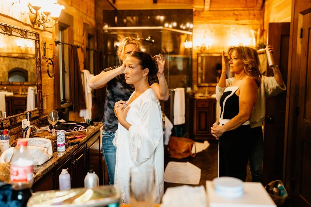 Bride Cayli getting ready in a Blue Ridge Georgia mountain cabin on her intimate wedding morning, candid getting-ready photography by Appalachian Wedding Photography