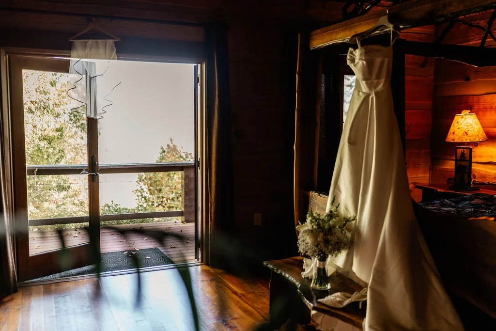Wedding dress displayed at a rustic Blue Ridge Georgia mountain cabin, intimate cabin wedding detail photography by Appalachian Wedding Photography