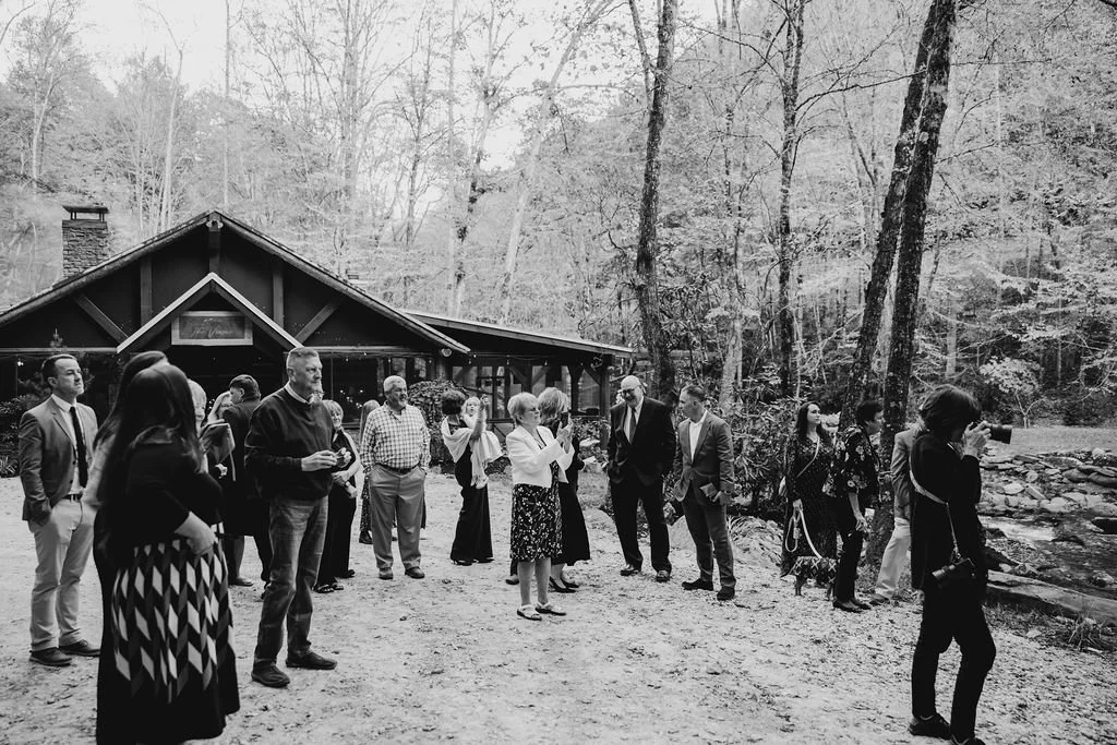 Black and white candid photo of a wedding guest at an intimate Blue Ridge Georgia Appalachian cabin wedding, candid photography by Appalachian Wedding Photography