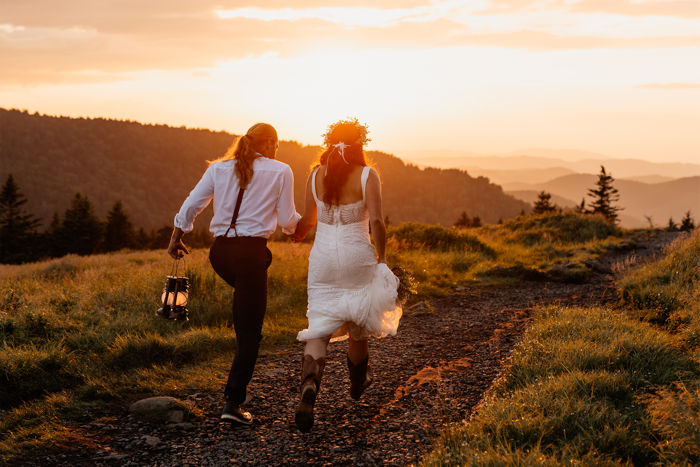 Couple running together at golden sunset during their elopement on Roan Mountain trail in the Appalachian mountains by Appalachian Wedding Photography