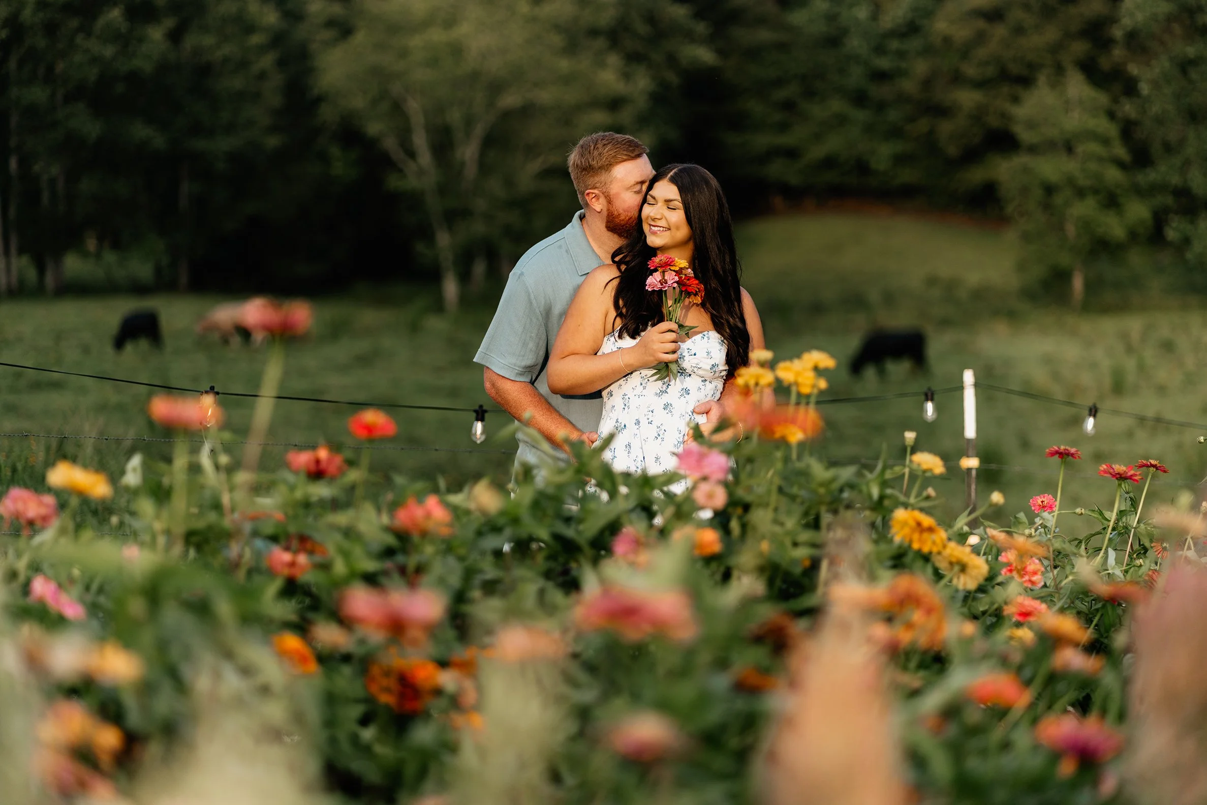 Trevor and Tessa standing together in a wildflower field during their Appalachian mountain elopement