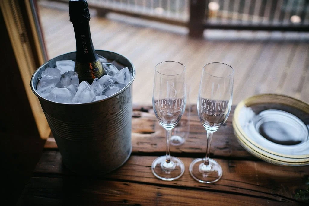 Elegant wedding bar setup with champagne glasses and an ice bucket, intimate mountain wedding detail photo, Blue Ridge GA intimate wedding photographer