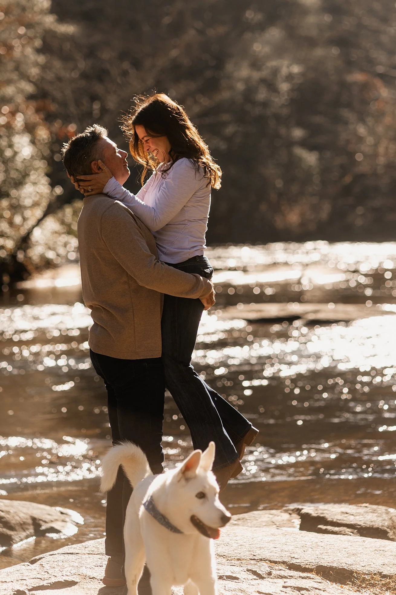Greg and Monica with their dog on rocky mountain stream during their Blue Ridge elopement