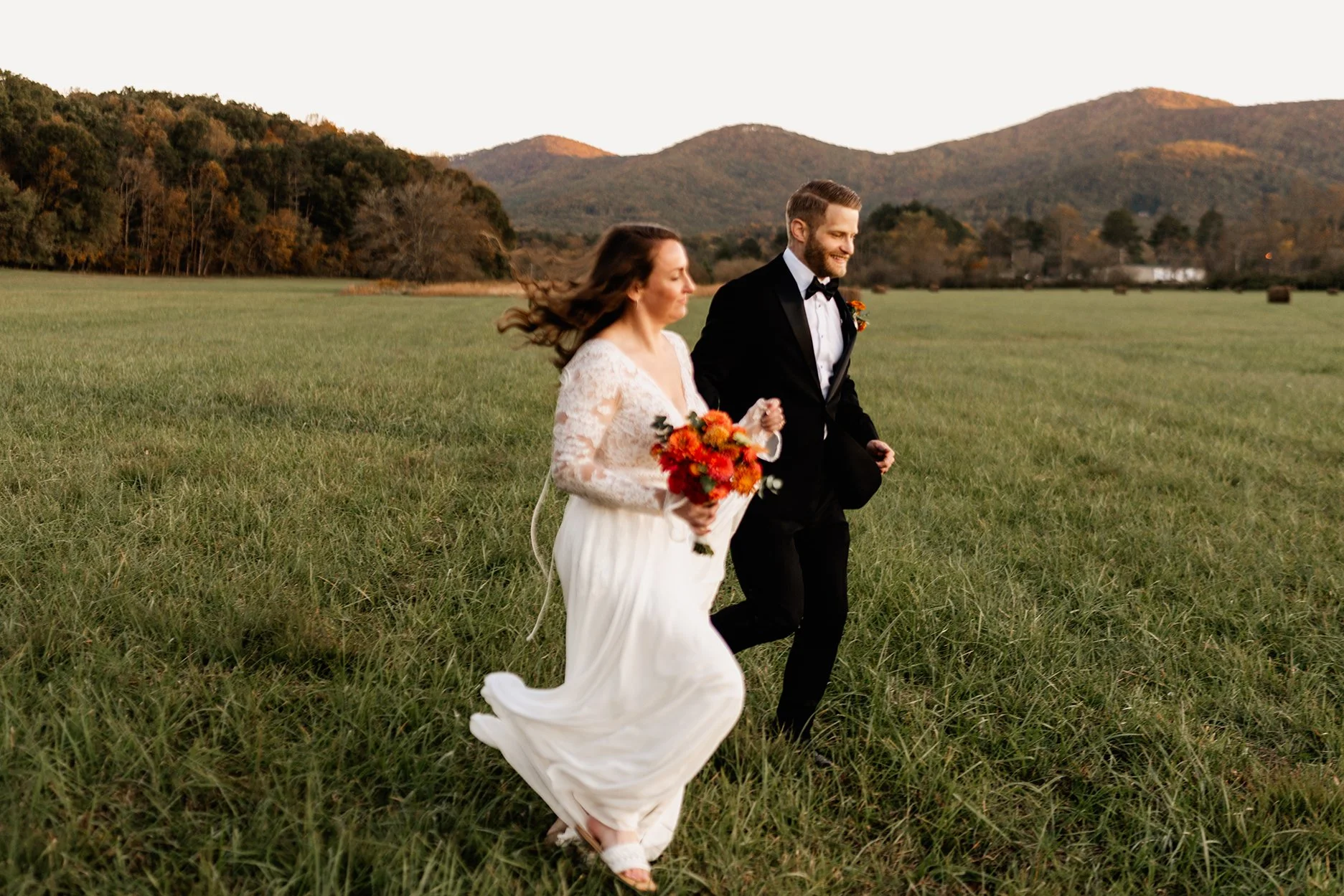 Mat and Kelsey couple portrait in a mountain meadow during their Western North Carolina wedding