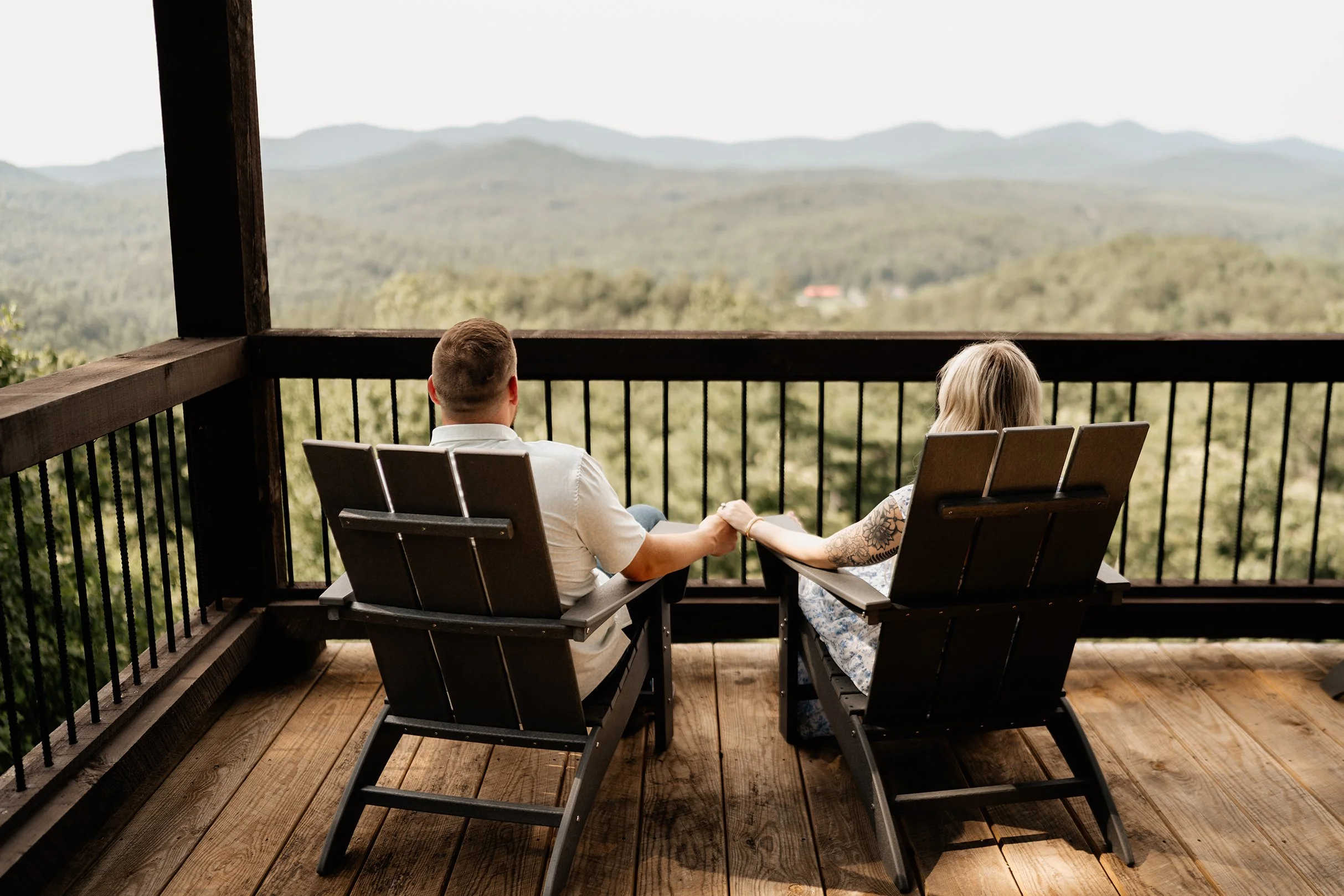 Chris and Meredith on a cabin porch overlooking a mountain valley during their Blue Ridge elopement