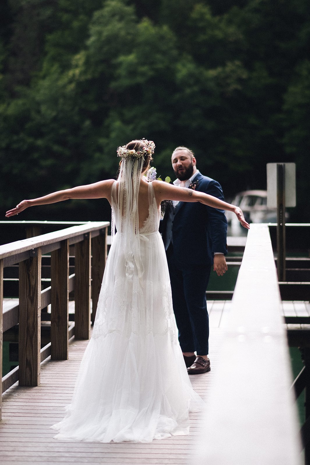 Bride's first look moment on a mountain lake dock captured by Appalachian wedding photographer