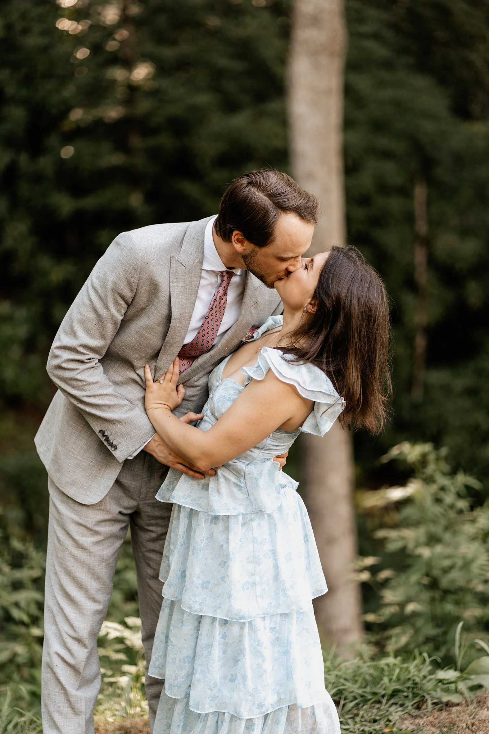 Greyson and Miranda kissing outdoors during their Appalachian mountain wedding