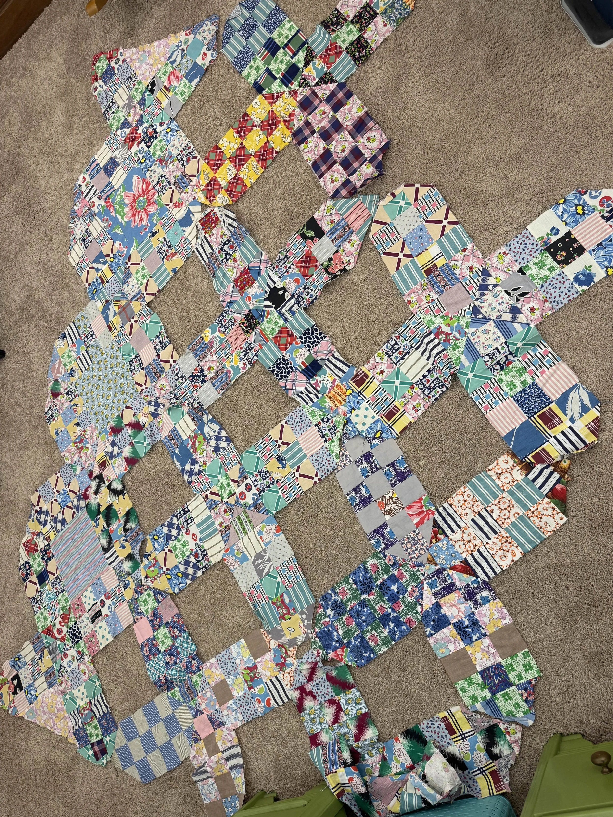 vintage x-shaped quilt blocks arranged onto the carpet