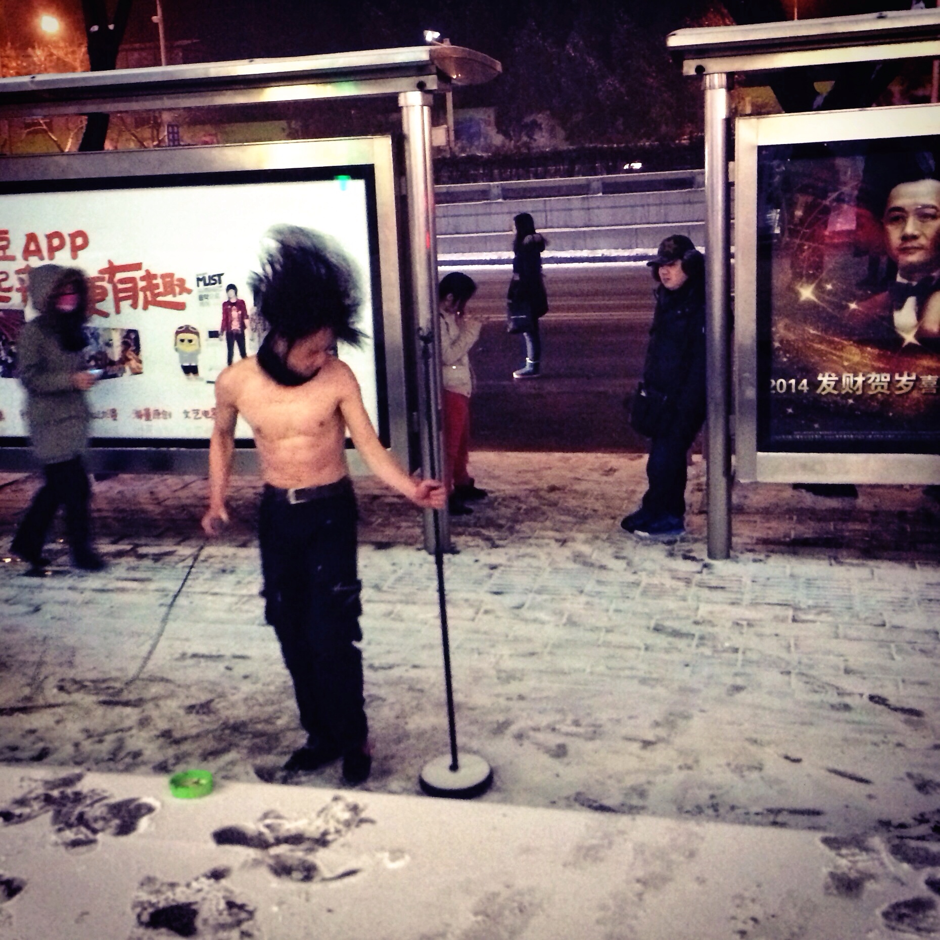 A heavy metal busker performs on a Beijing street in winter.
