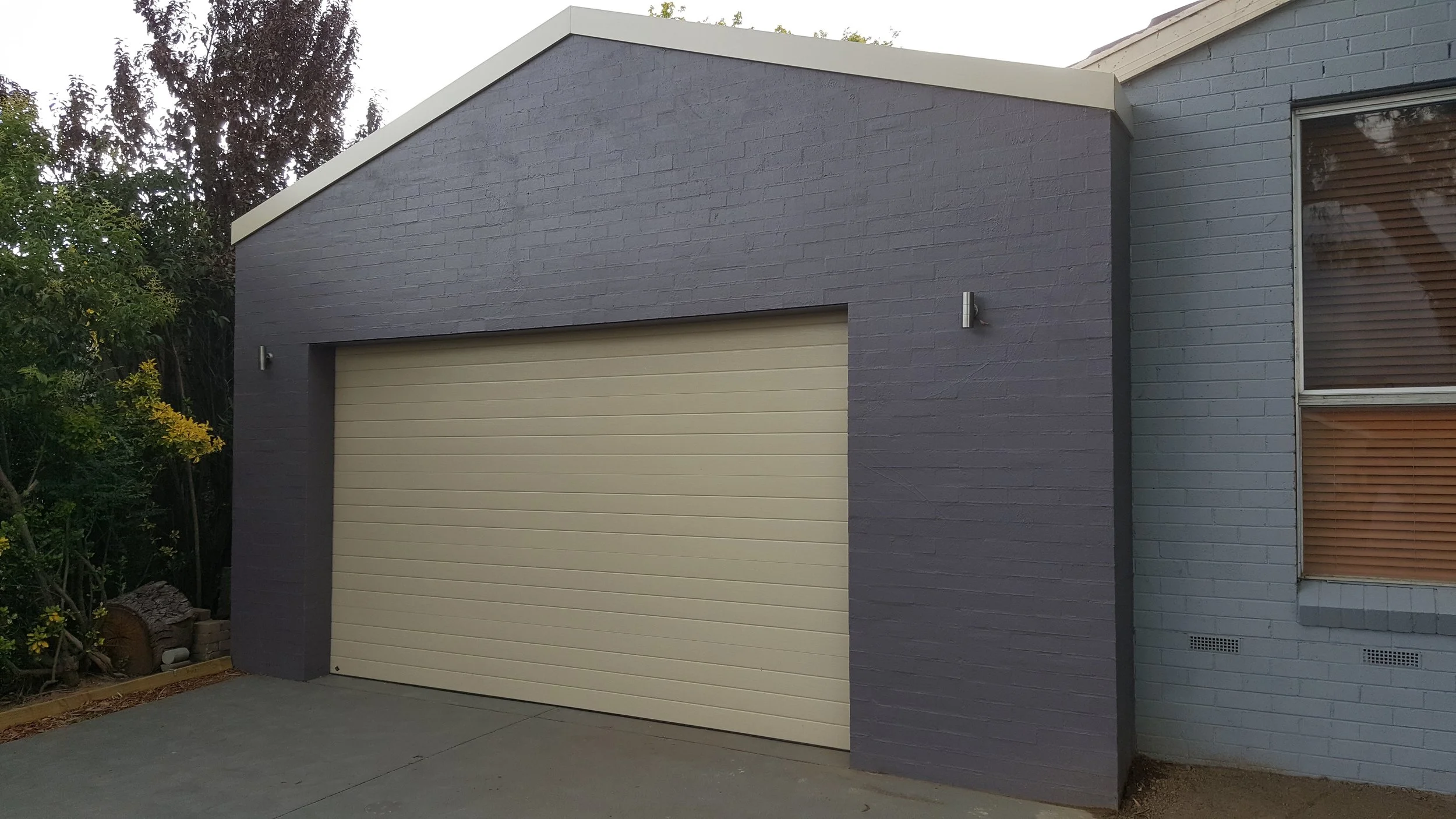 Bagged brick front carport and panel lift door.jpg