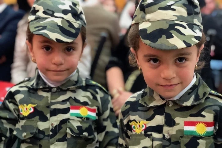 Kids wearing uniforms with father's rank