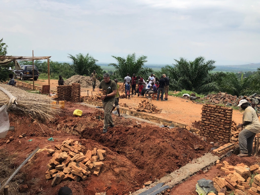 Matt carrying bricks as the walls start to be built.