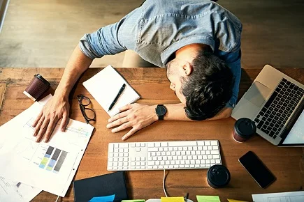 iStock-sleeping-lazy-idle-office-tired-exhausted-overworked-625737620.jpg
