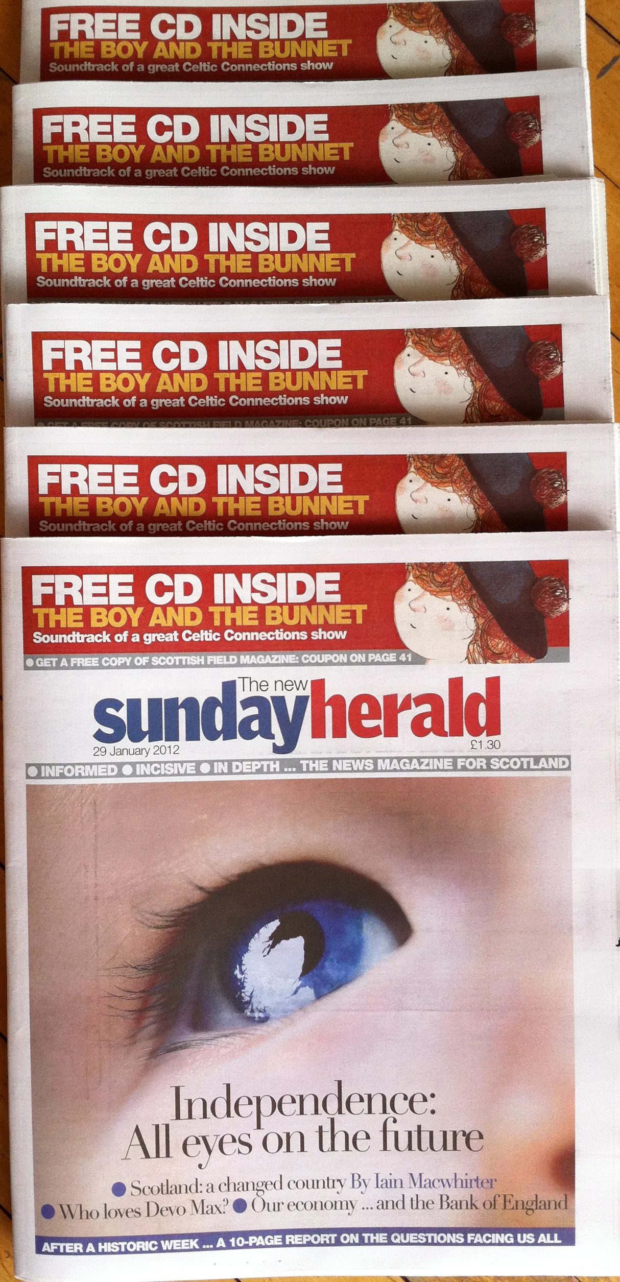 A photograph of the newspapers featuring my illustrations for The Boy and the Bunnet.