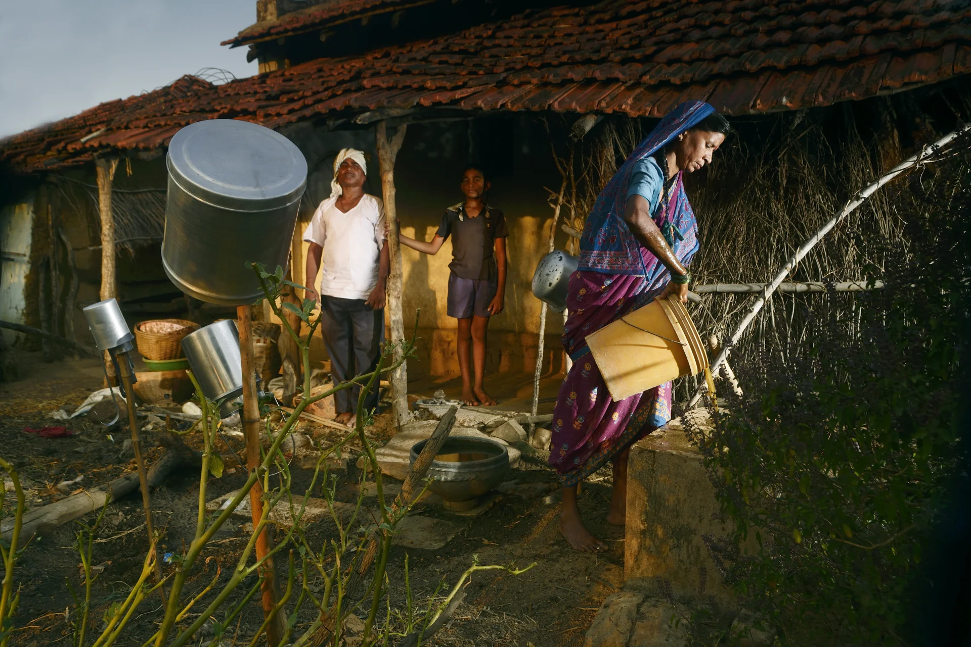 54-year-old Sarawan Tulsi Ram Wadankar returns home in the evening. His wife pours cow dung into their biogas plant which meets their cooking gas requirements.