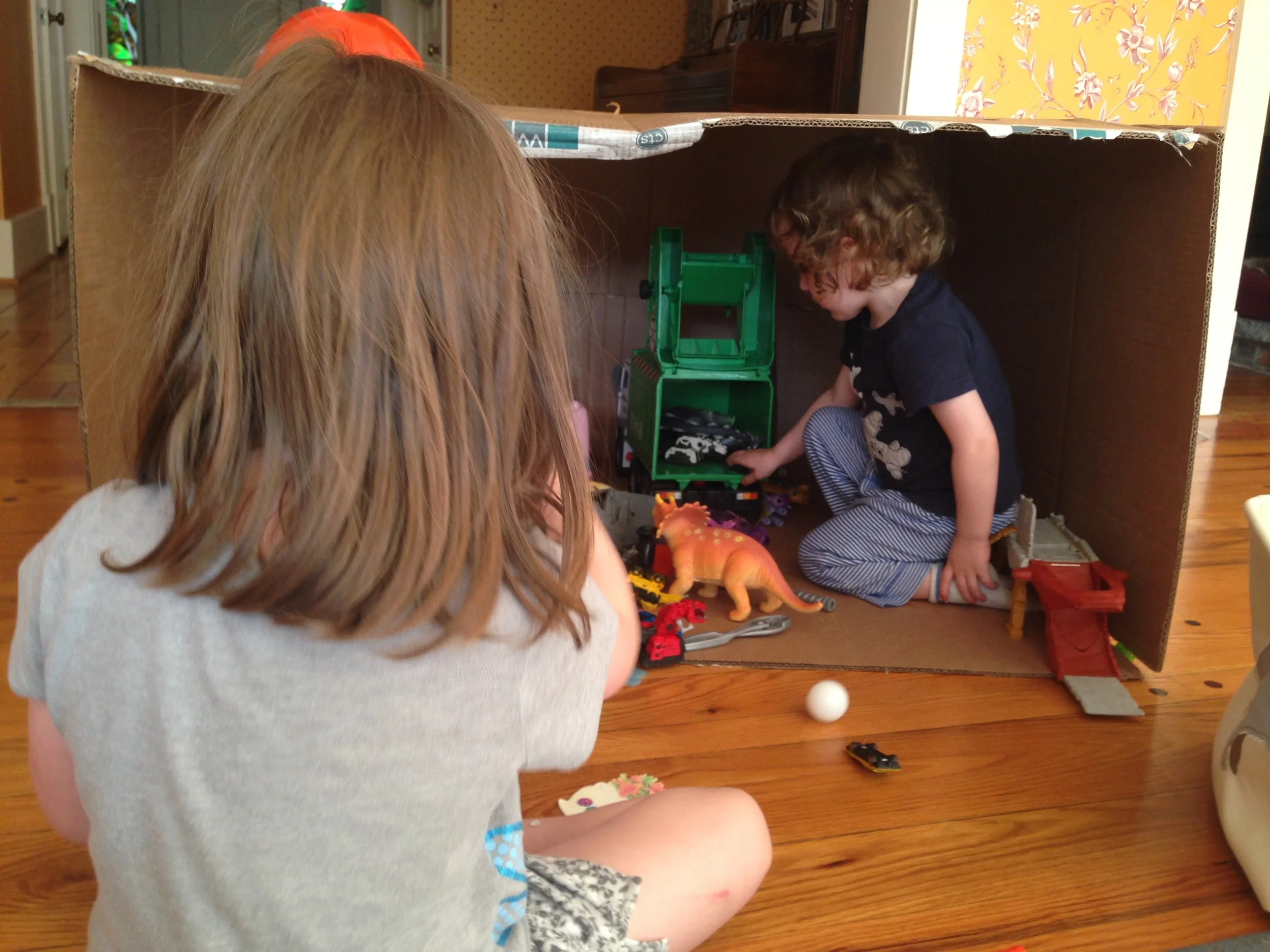 A new home for favorite toys. Note the Dinotrux "bad guys" figures stored in the back of a garbage truck.