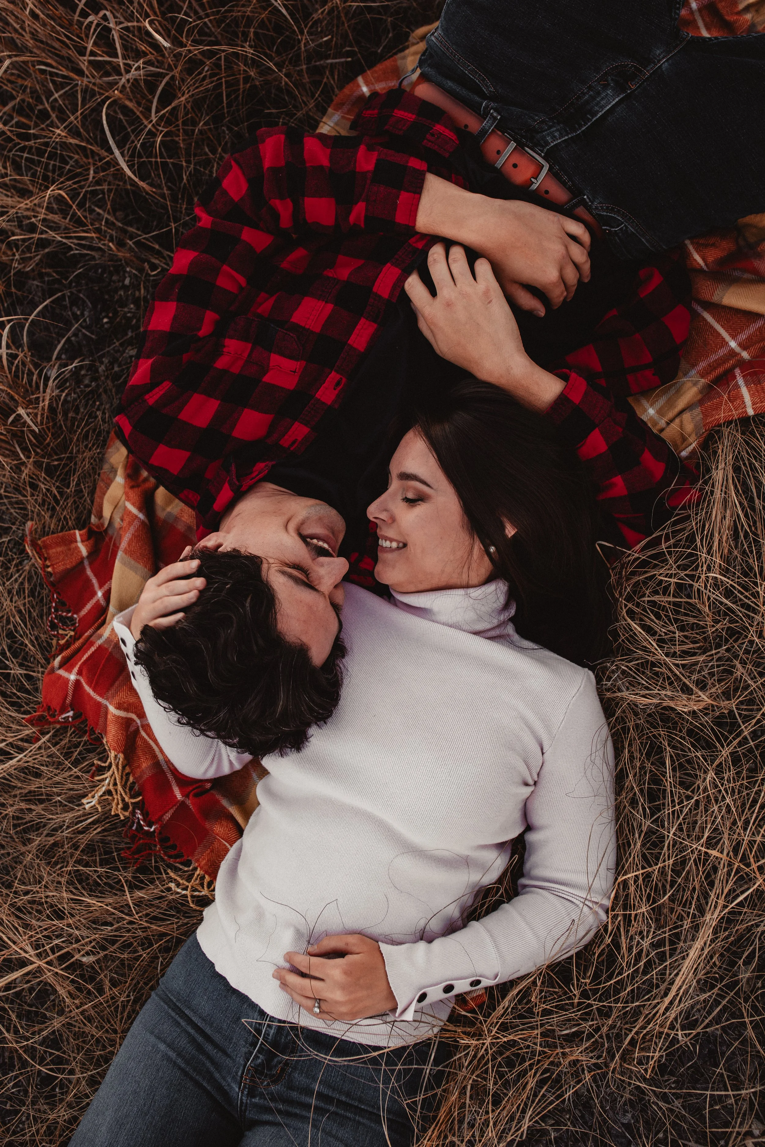 Engagement session in a field at a sunset