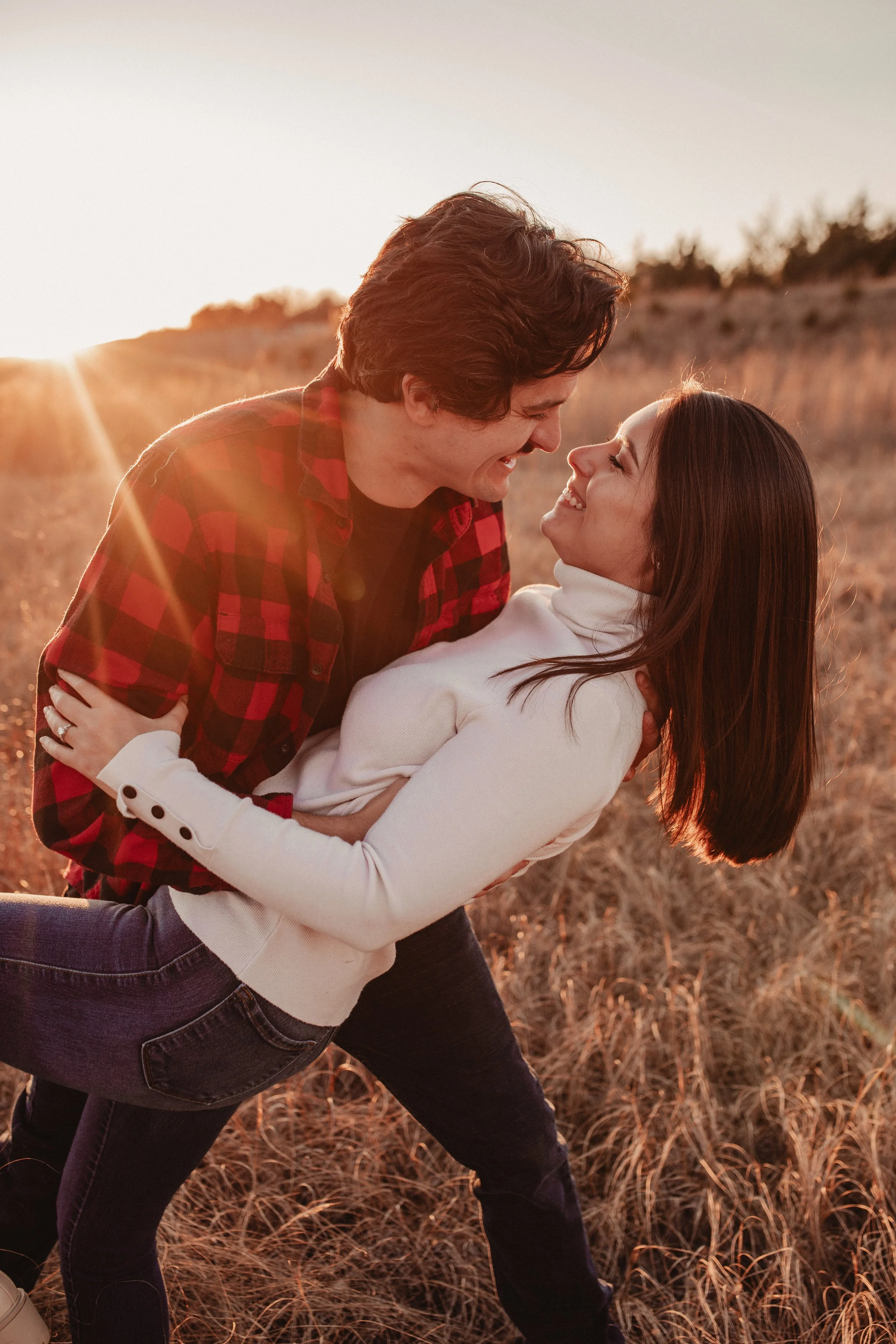 Engagement session in a field at a sunset