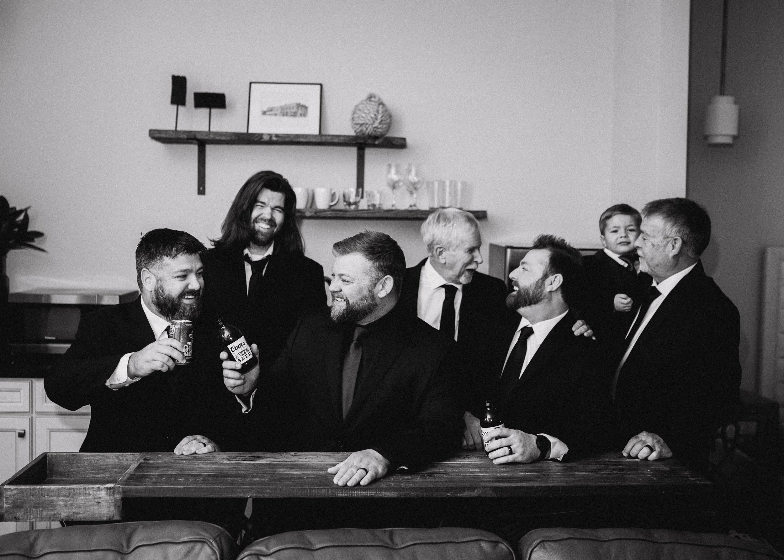 Groom and groomsmen sharing a toast while getting ready for a wedding in Loveland, Ohio.