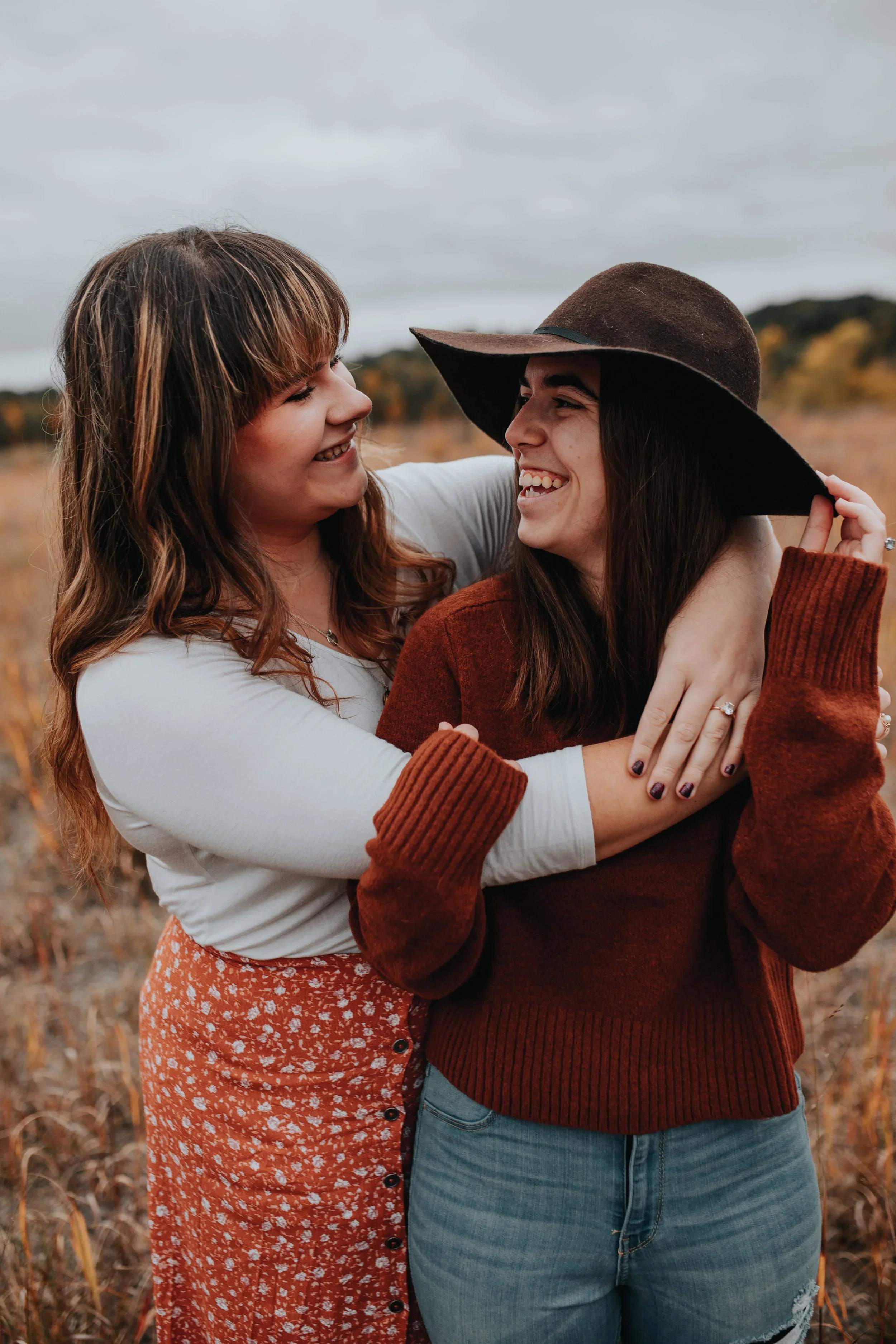 Engaged couple sharing a joyful moment together outdoors in Cincinnati, Ohio, photographed by Sarah and Jordan of Every Atom Photography