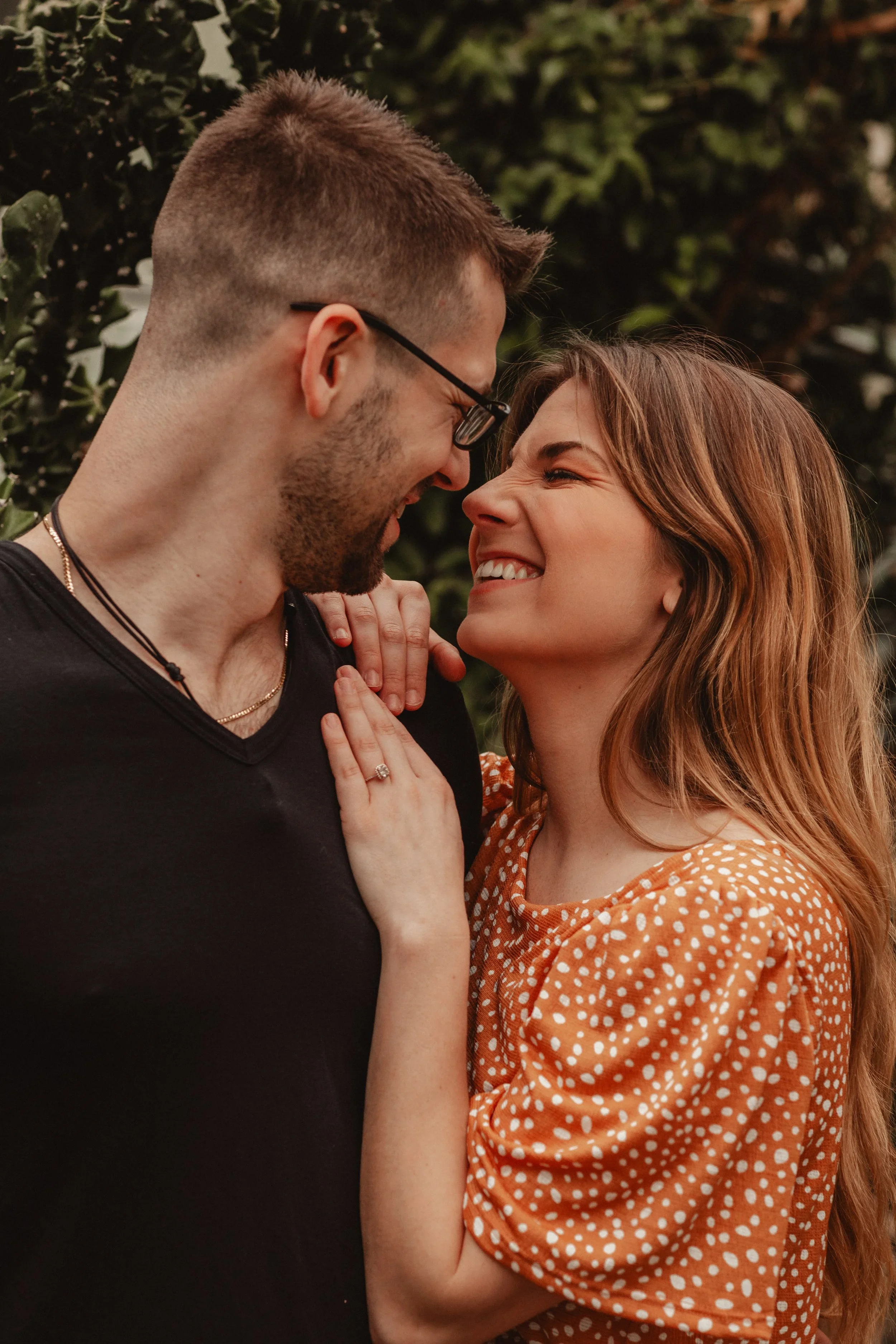 Candid close-up of an engaged couple laughing together during a Cincinnati engagement session photographed by Sarah and Jordan of Every Atom Photography