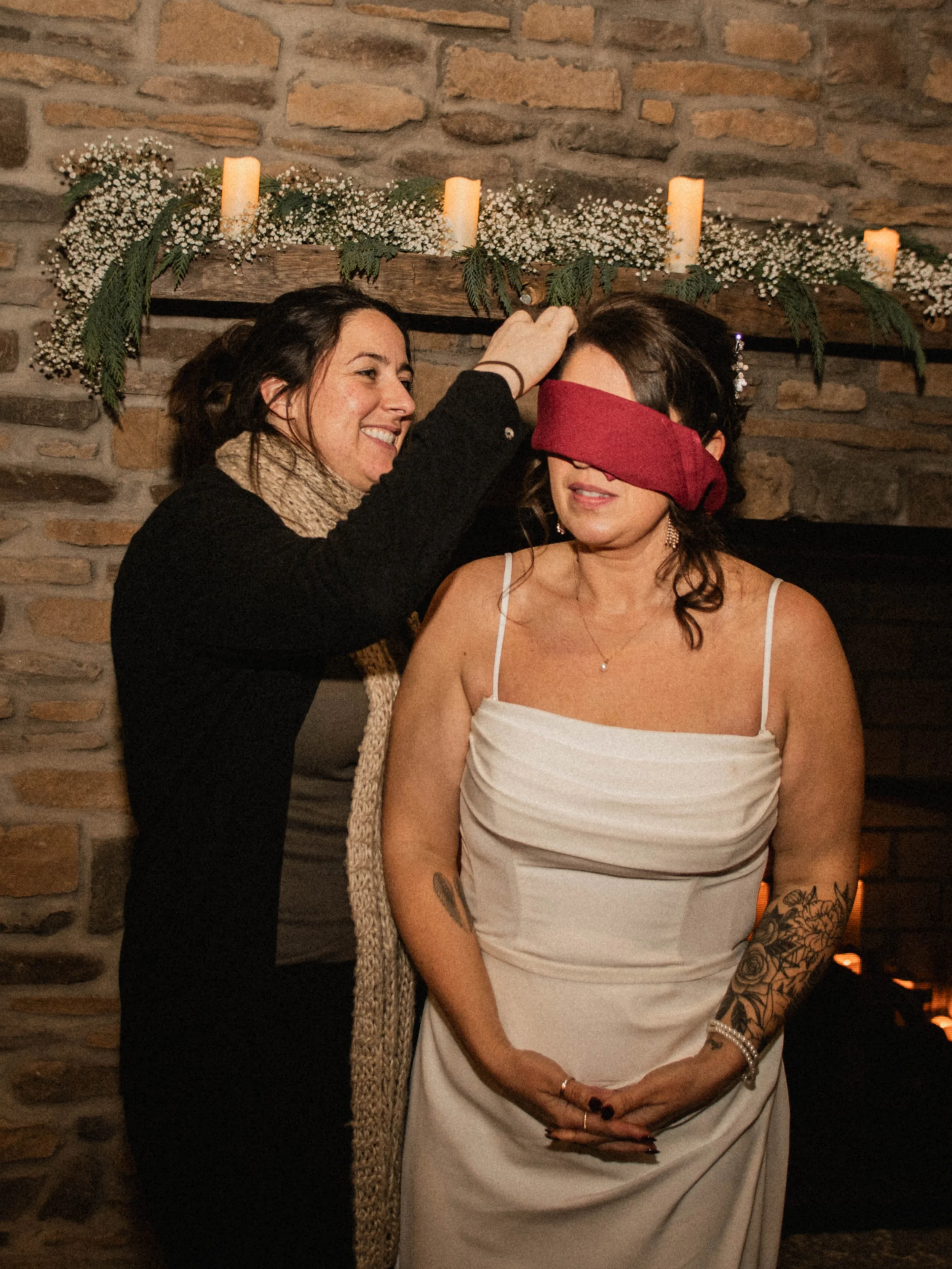 Bride participating in a blindfold game during a wedding reception at The Landing Event Center in Loveland, Ohio.