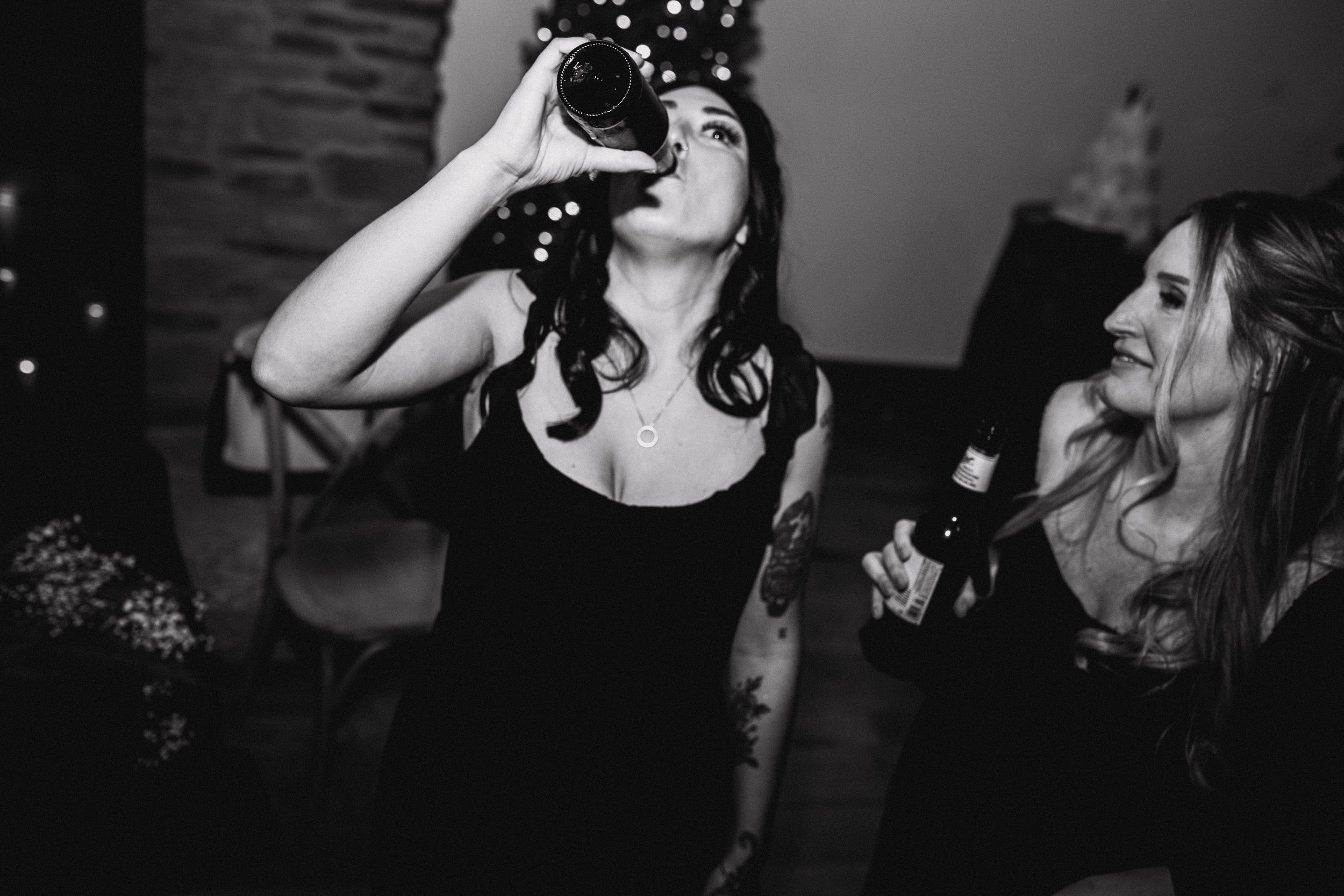 Wedding guests celebrating and enjoying drinks during the reception at The Landing Event Center in Loveland, Ohio.